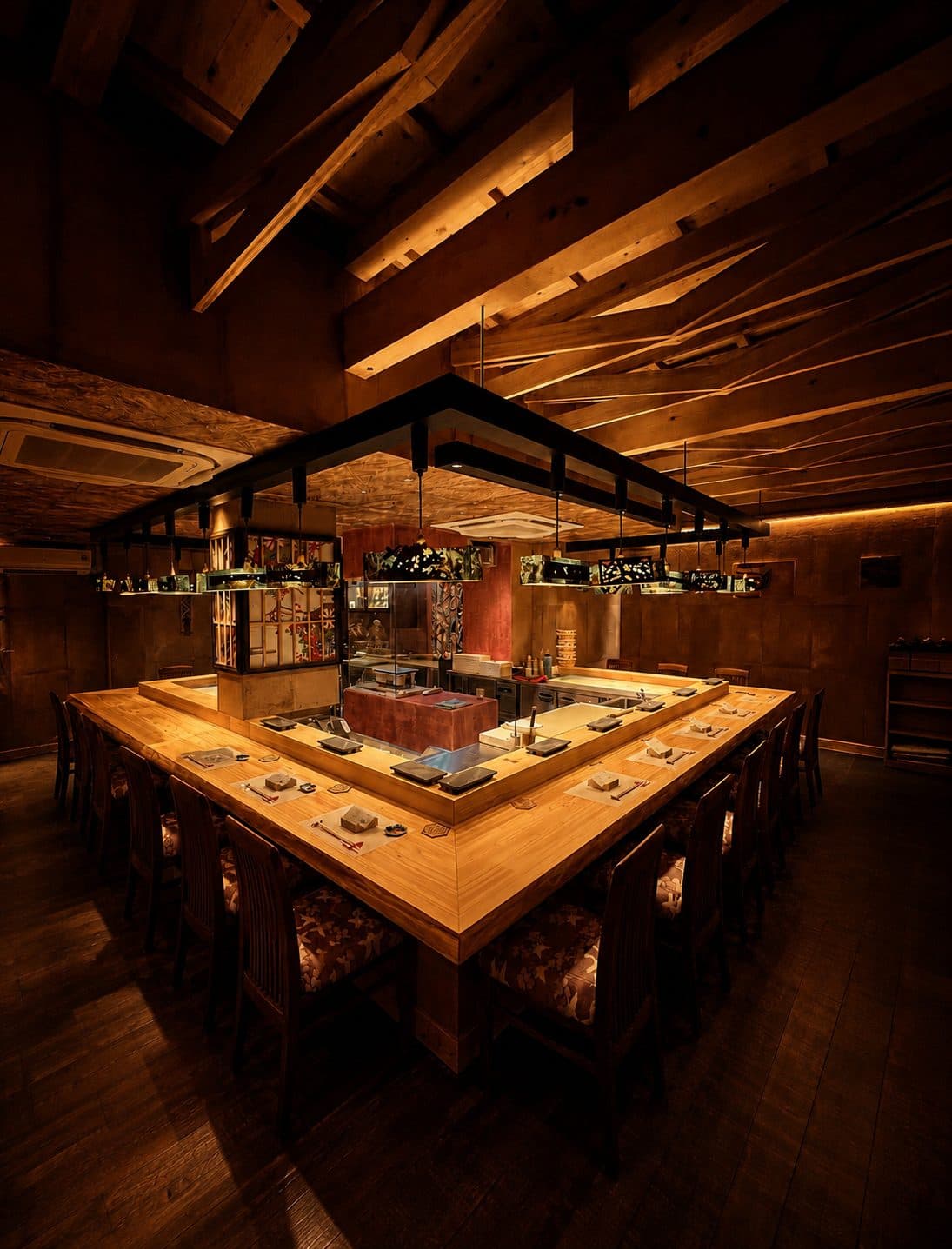 Inside Sushi Iwai: a counter and beamed ceiling of Niyodogawa timber, warmed by low light